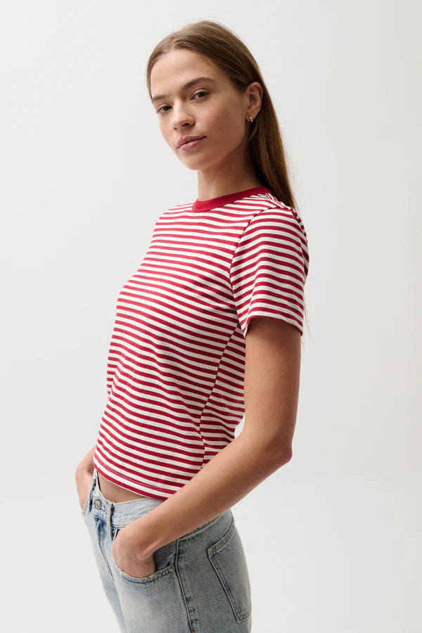Woman wearing a red and white striped t-shirt against a plain background