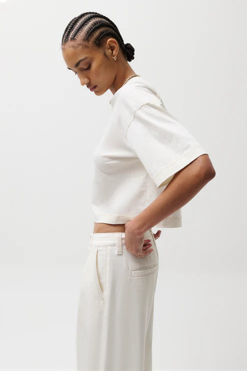 Person wearing a white outfit on a plain background