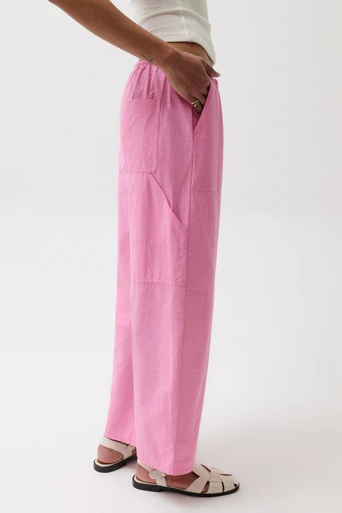 Person wearing pink pants on a white background