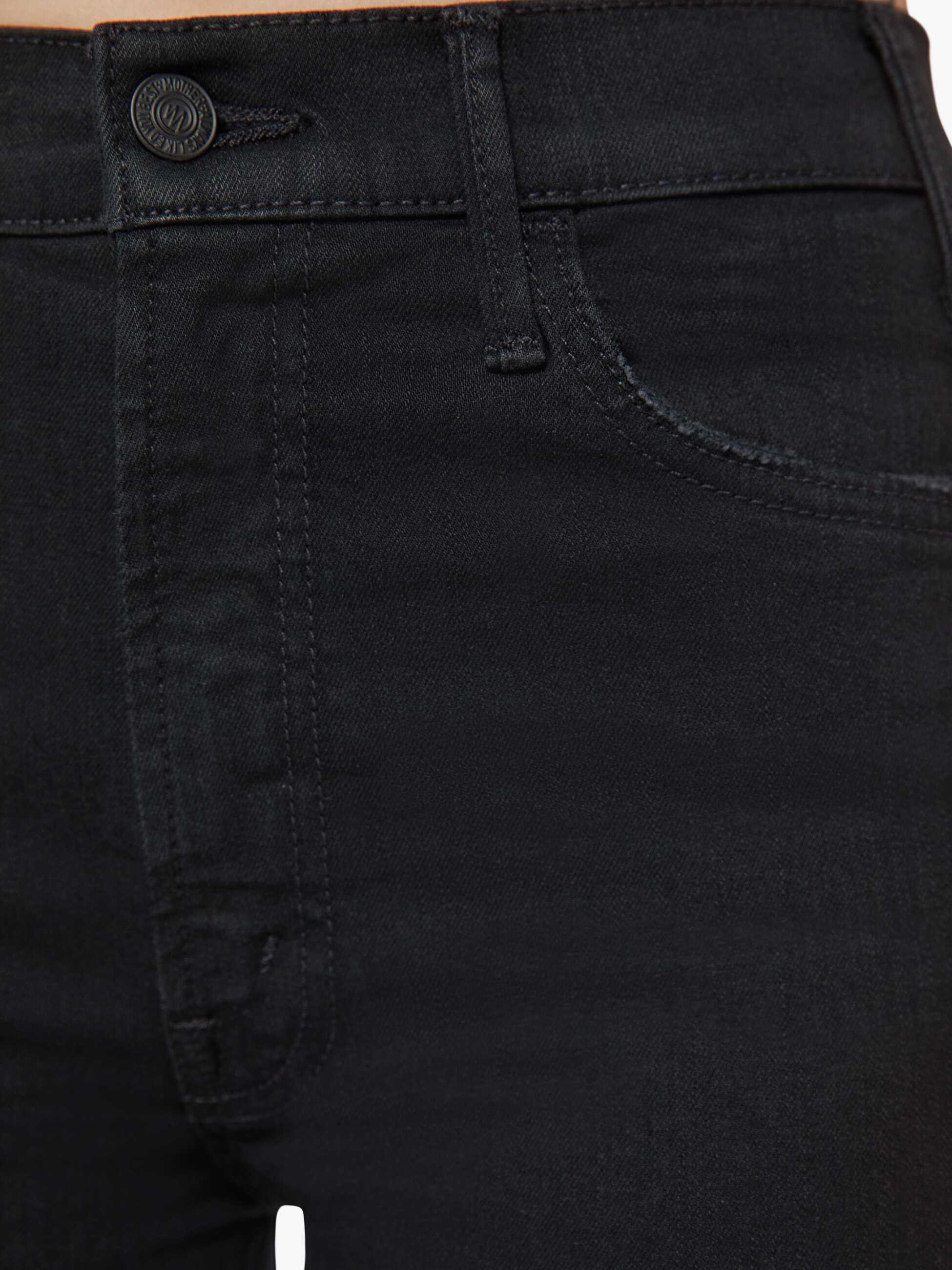 Close-up of black pants with a button and stitching detail.