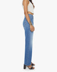 Woman wearing blue jeans and a white top on a white background