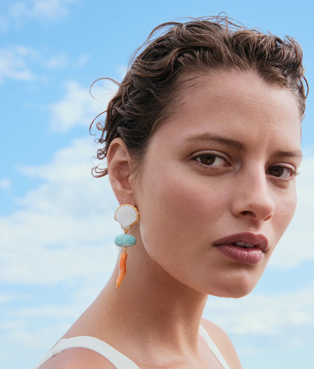 Woman wearing Luna Drop Earrings with a blue sky background