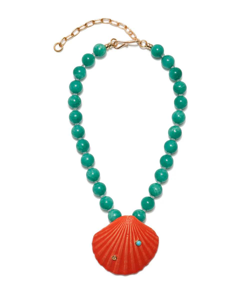 Necklace with turquoise beads and a red shell pendant on a white background
