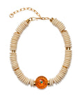 Necklace with beige beads and a large orange bead on a white background