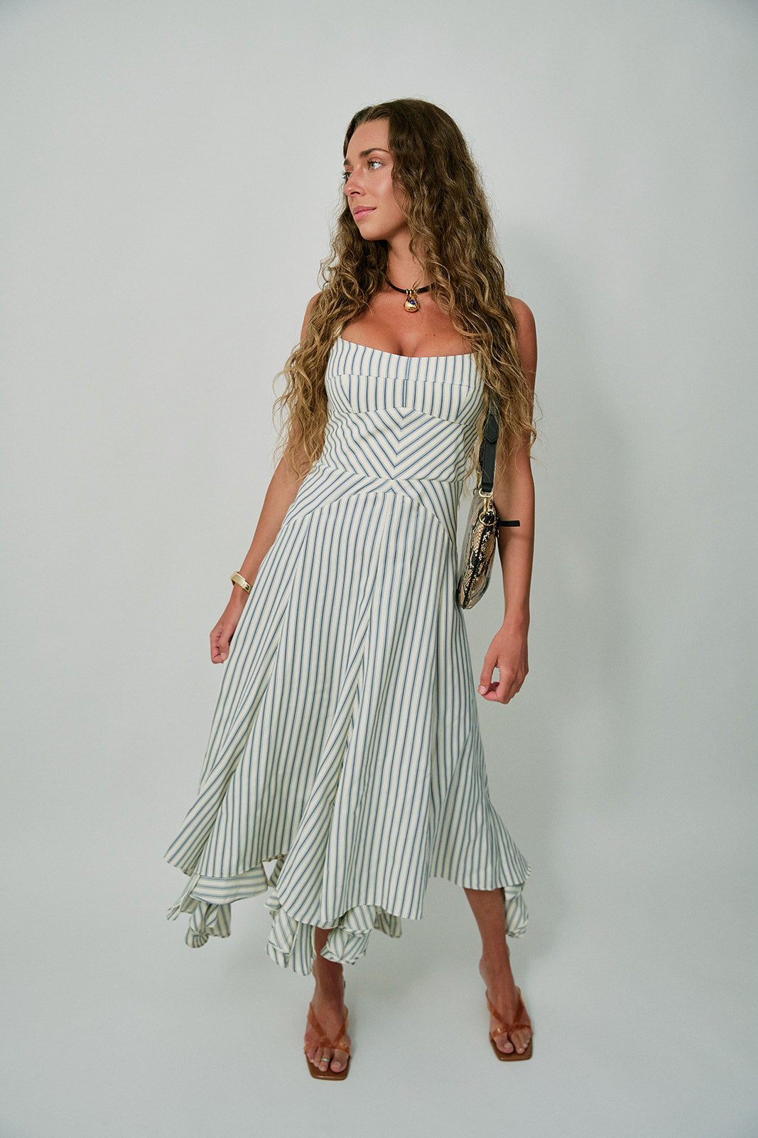 Woman wearing a striped dress against a plain background with Brevel Vinyl Heels