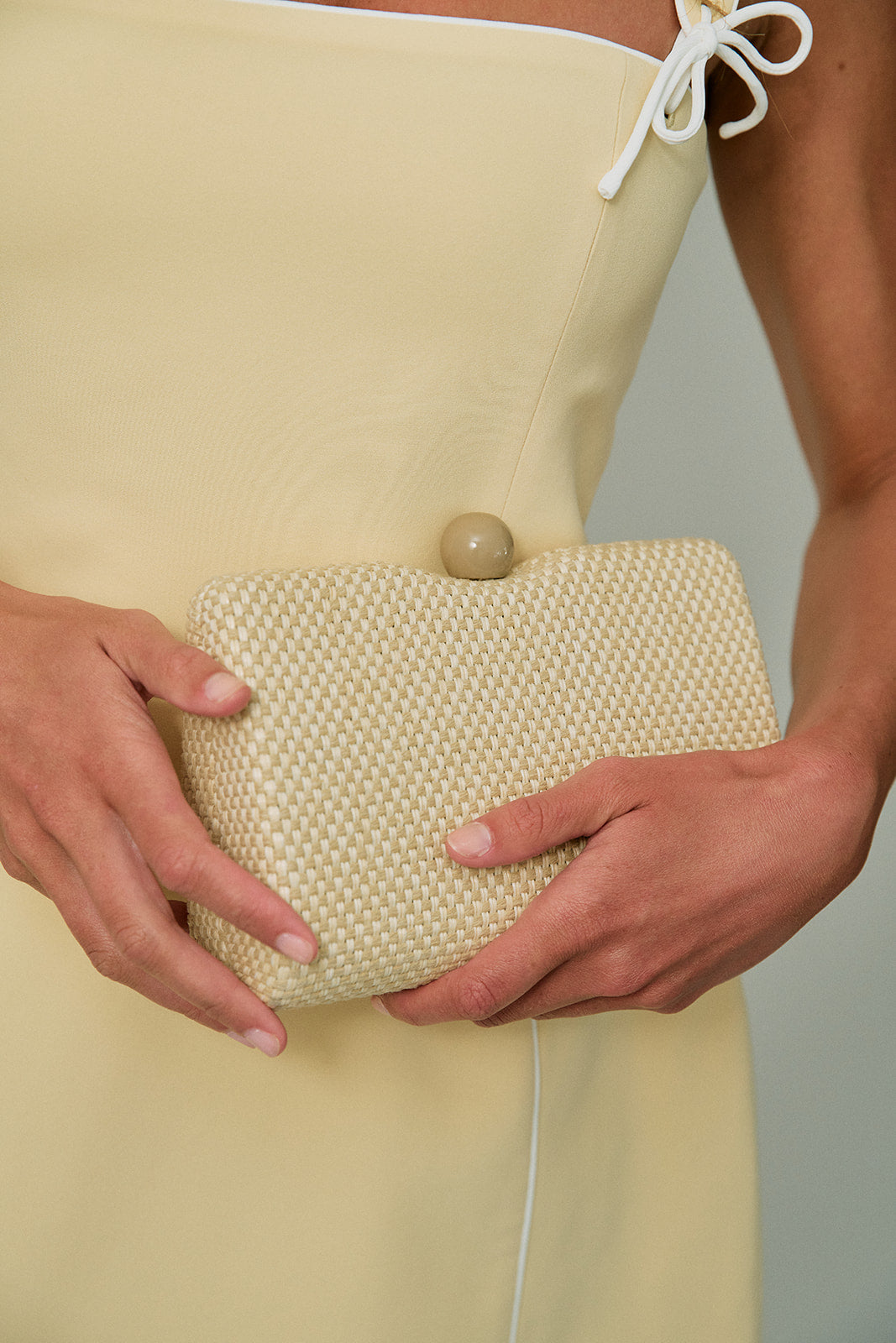 Marissa Evening Bag close up against yellow romper