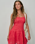 Woman wearing a red dress with Miranda Hoops and Miranda Charm Necklace