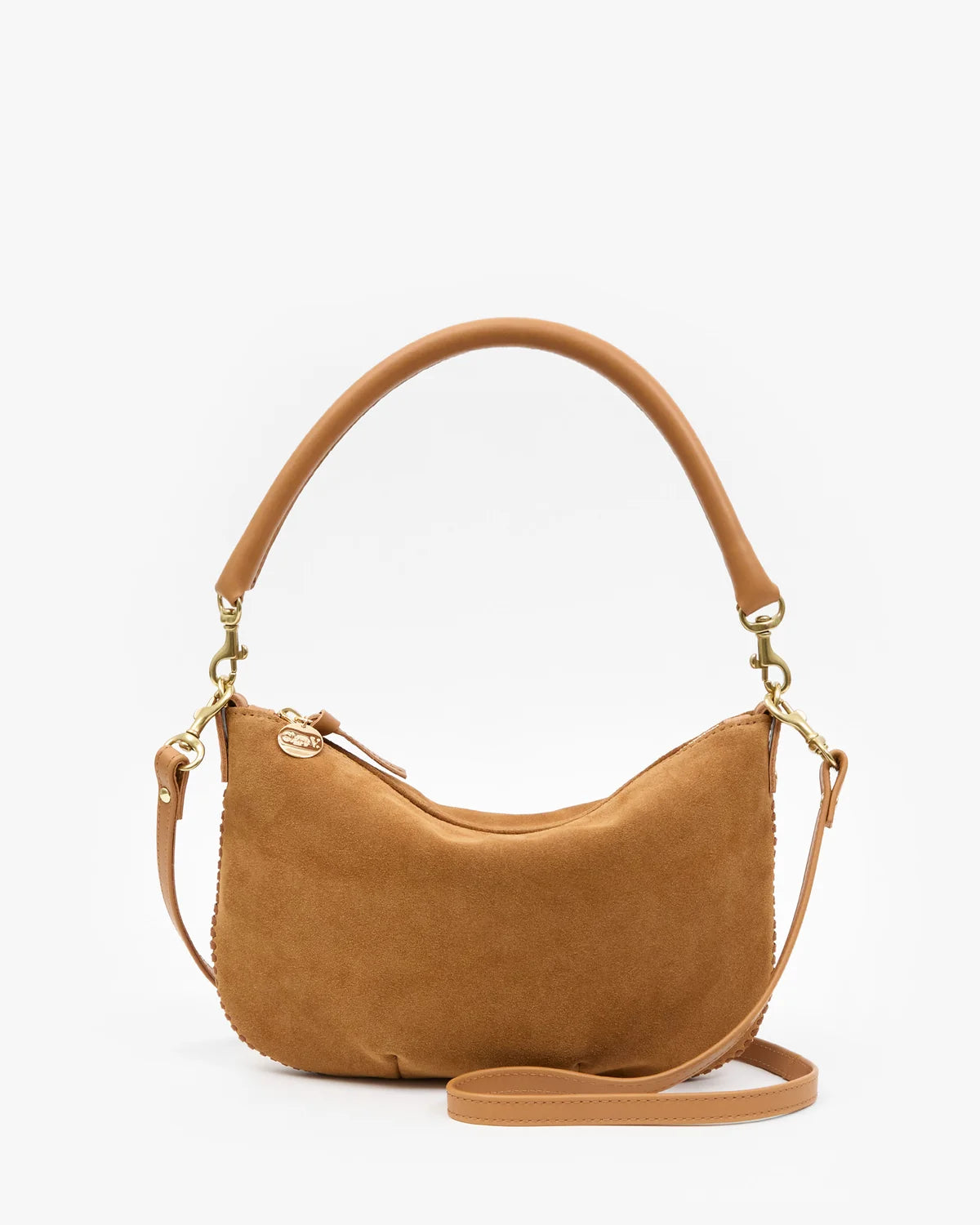 A tan suede crescent-shaped shoulder bag with a matching top handle and a detachable shoulder strap, accented with gold-tone hardware, shown on a plain white background.