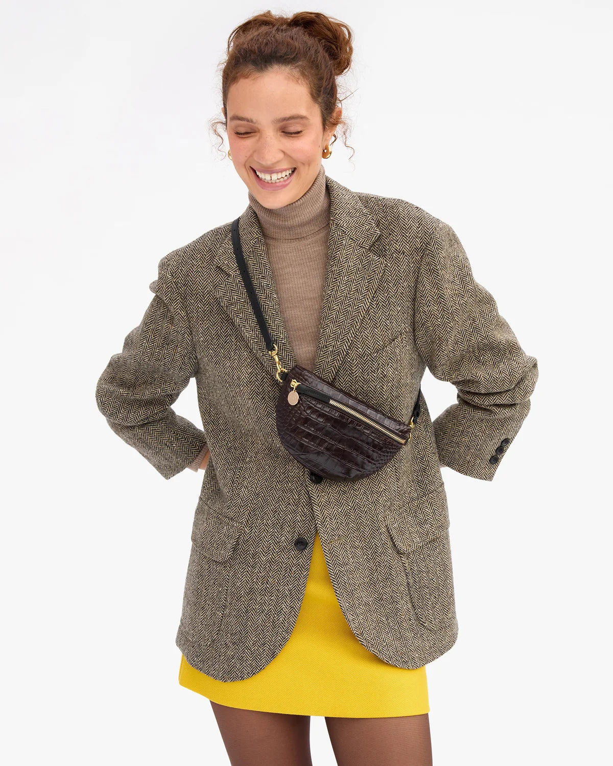 model wearing a houndstooth blazer and cross body mahogany bag