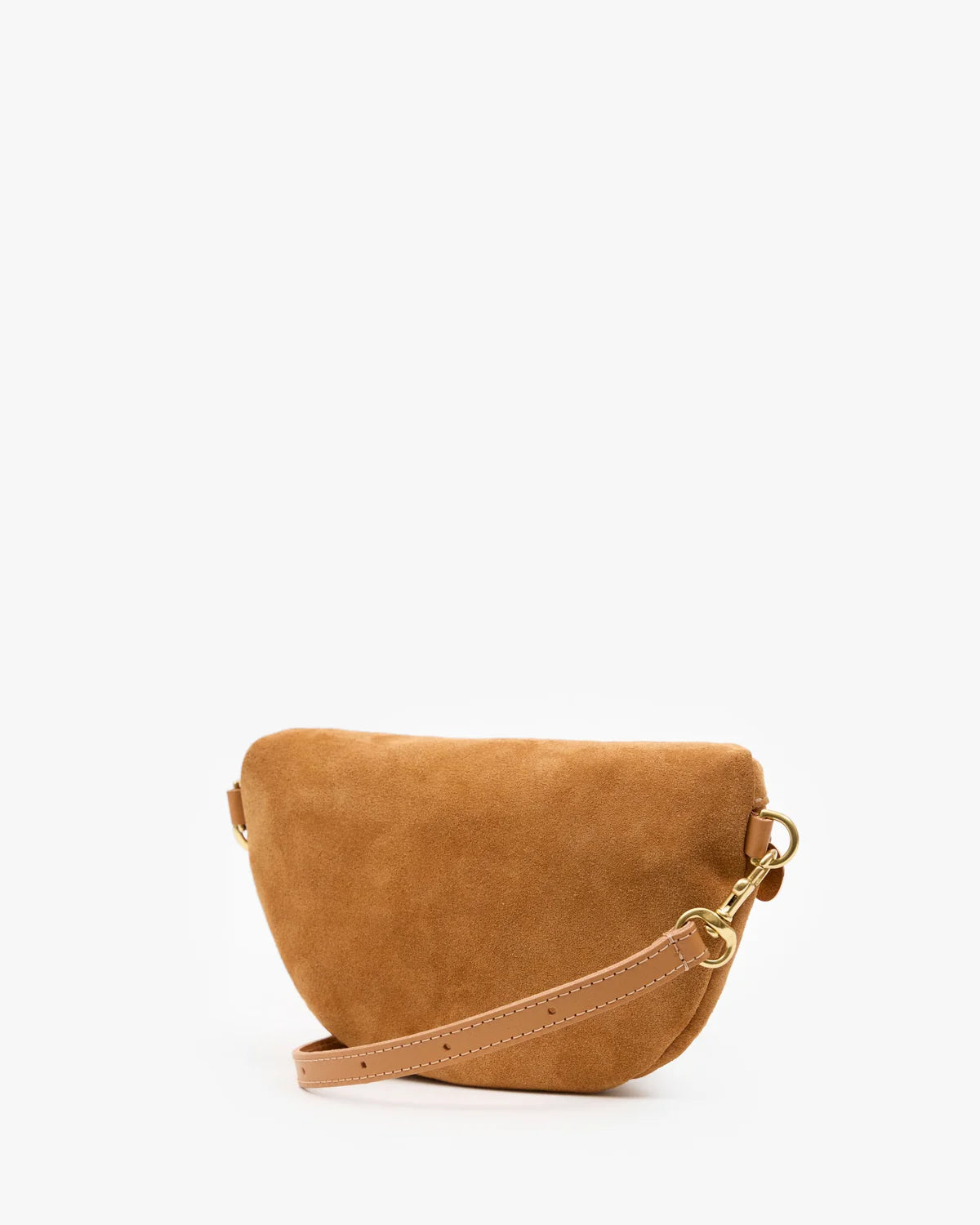 A small camel-colored suede crescent-shaped shoulder bag with a tan leather strap and gold-tone hardware, photographed on a clean white background.