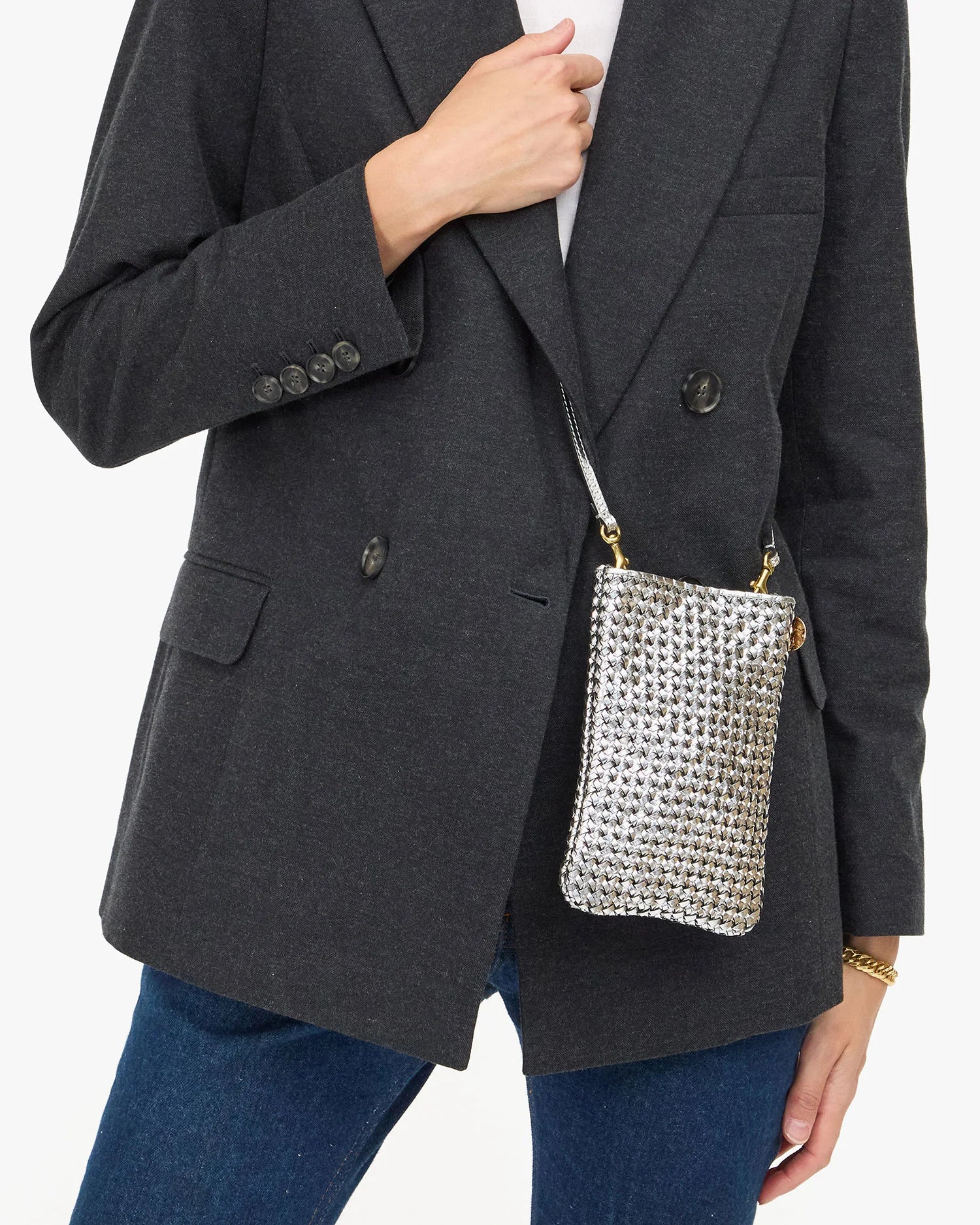 small poche silver bag crossbody on a model with a blazer and jeans