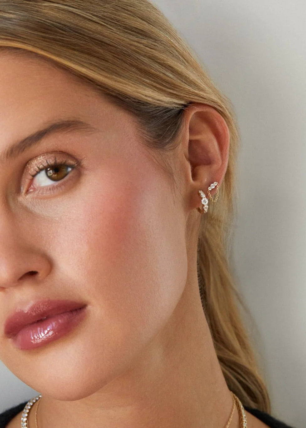 Single Graduated Diamond Bar Chain Stud Earring on ear in second hole