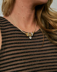 Desta Necklace close up against striped dress