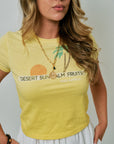 Woman wearing a yellow t-shirt with graphic design and text.