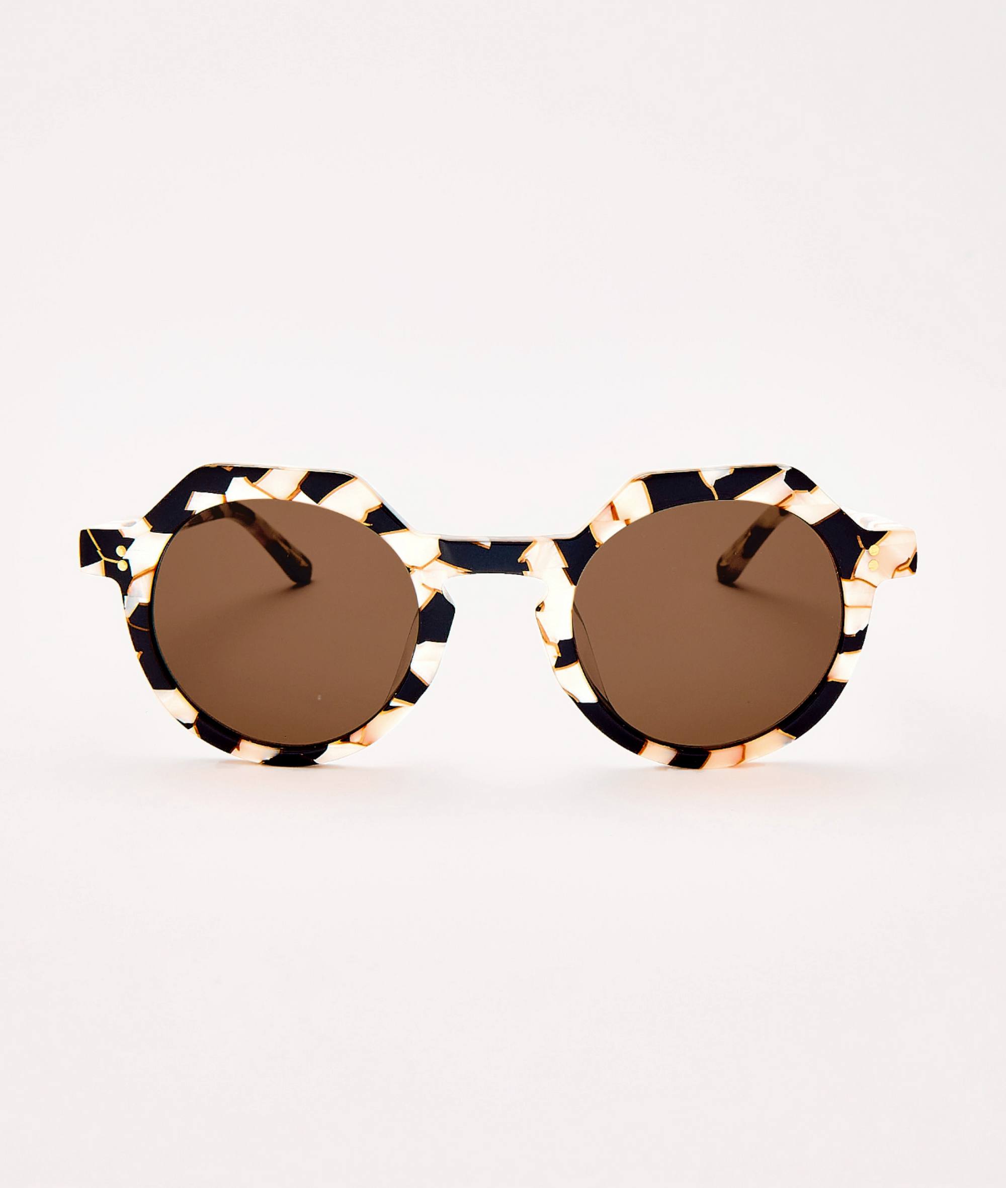 Round sunglasses with brown lenses and black and gold frame on a white background