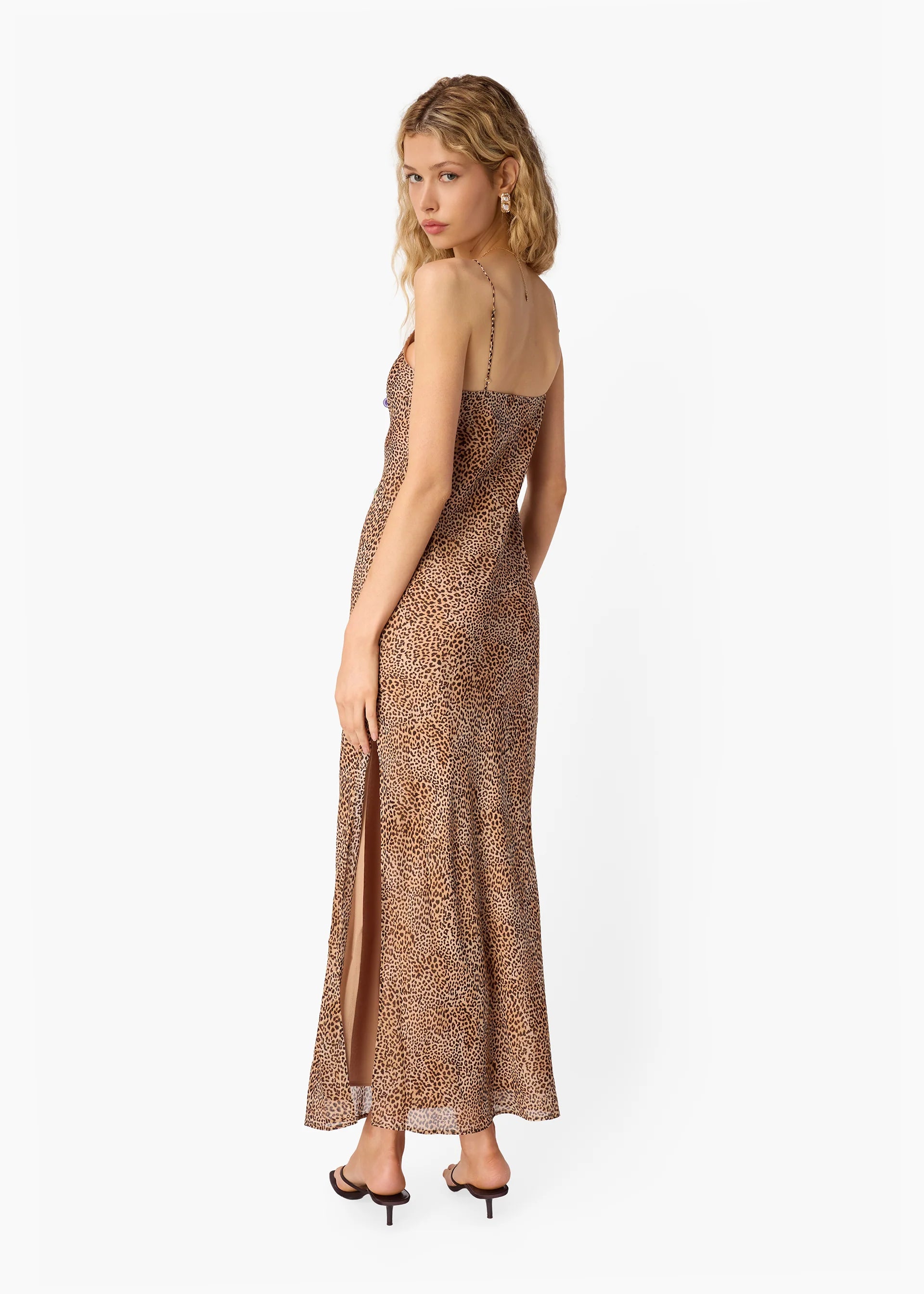 Woman wearing a leopard print dress on a white background