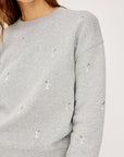 Gray sweatshirt with small martini embroidery on a light gray background