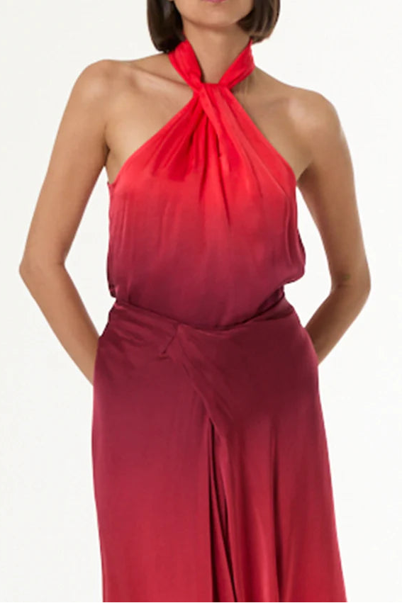 Woman wearing a red halter neck dress on a white background