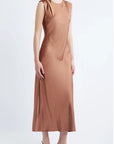 model wearing a cinnamon colored sleeveless midi dress on a white background, side