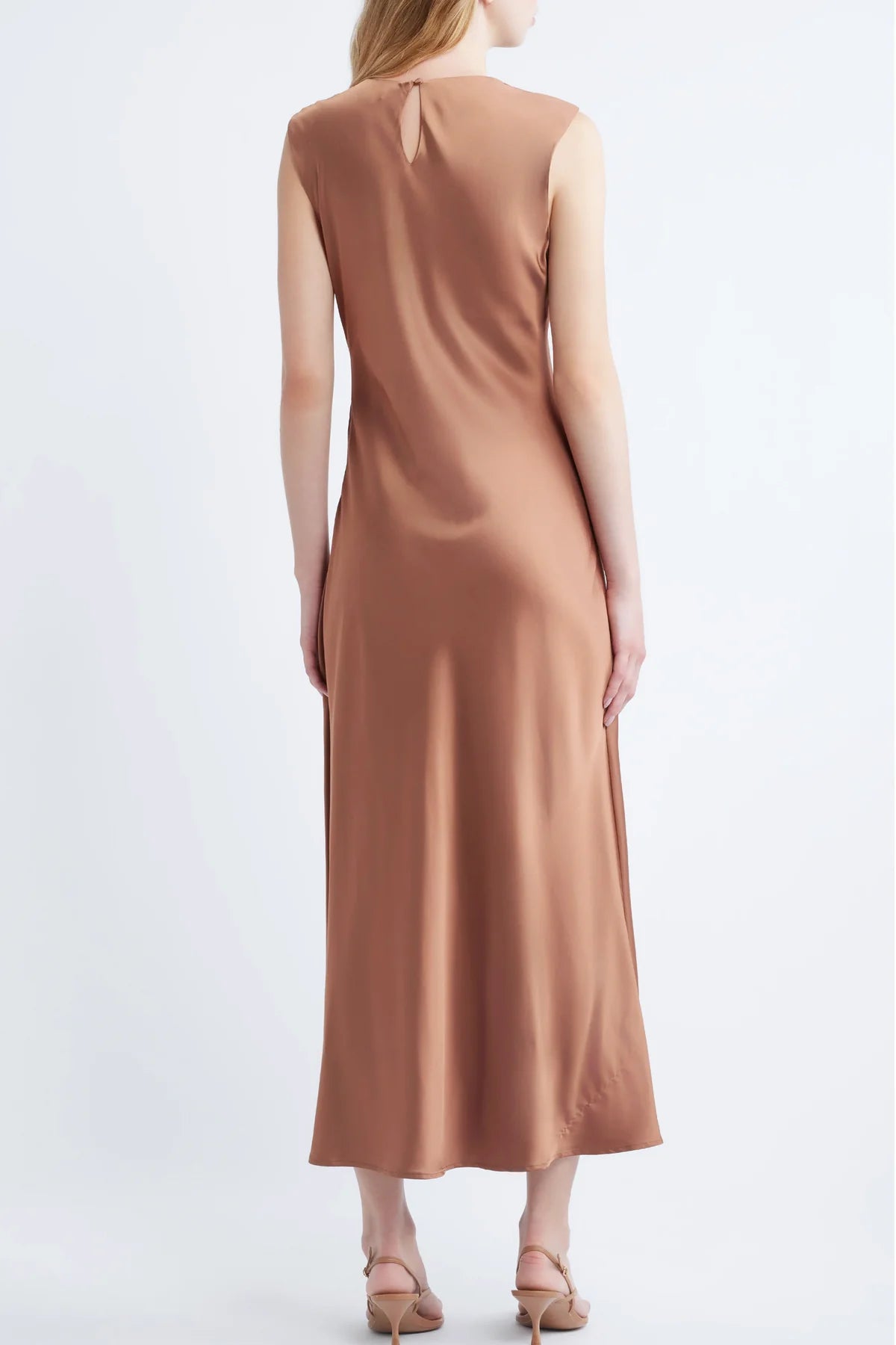 model wearing a cinnamon colored sleeveless midi dress on a white background, back 