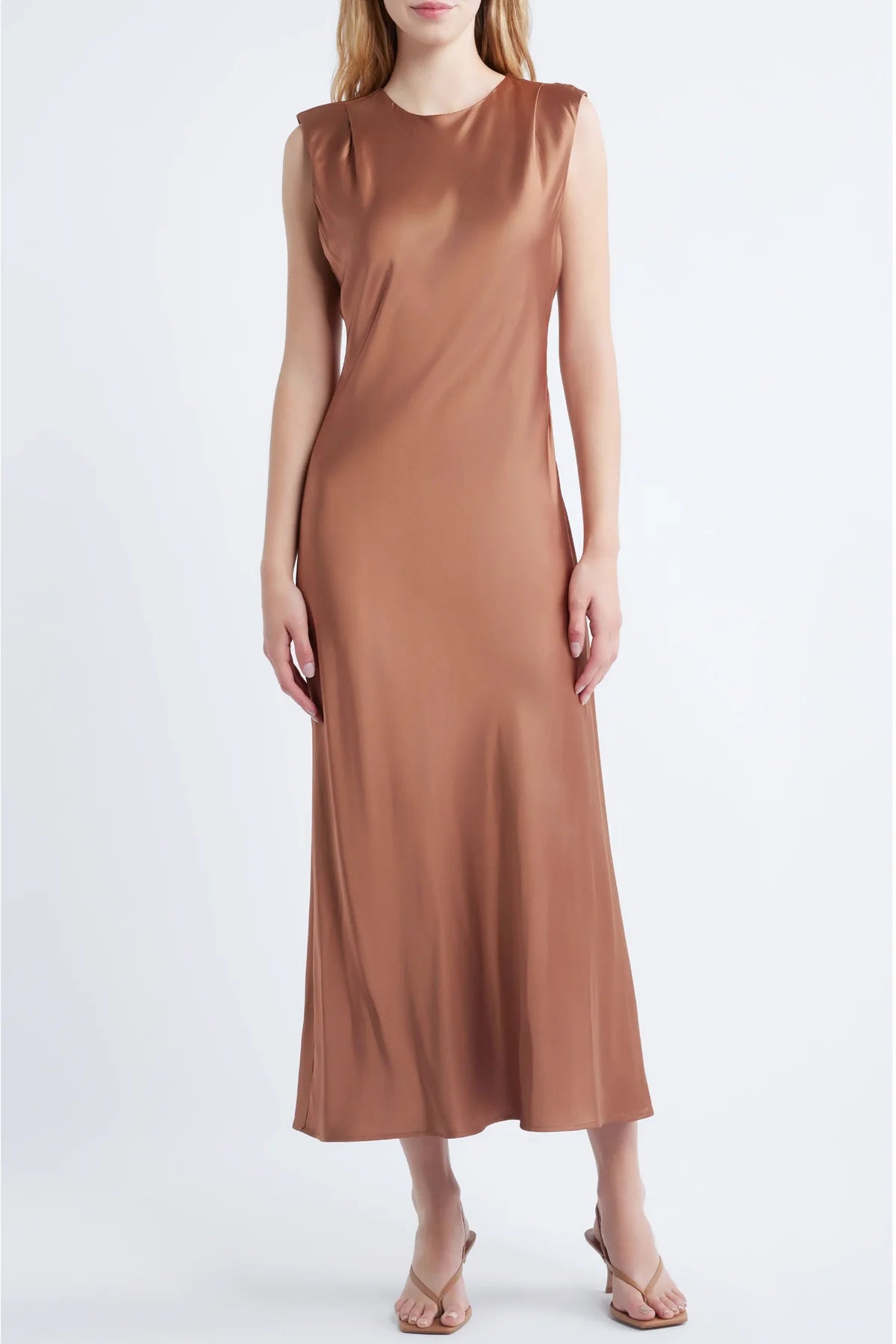 model wearing a cinnamon colored sleeveless midi dress on a white background