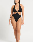 model wearing a black cut out one piece on white background