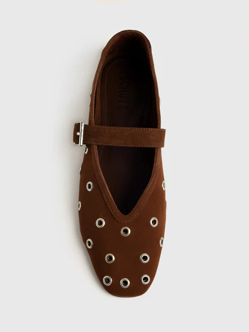 Brown flat shoe with eyelets on a white background