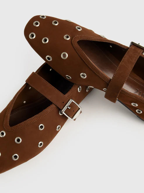 Brown leather sandals with eyelets and buckles on a white background