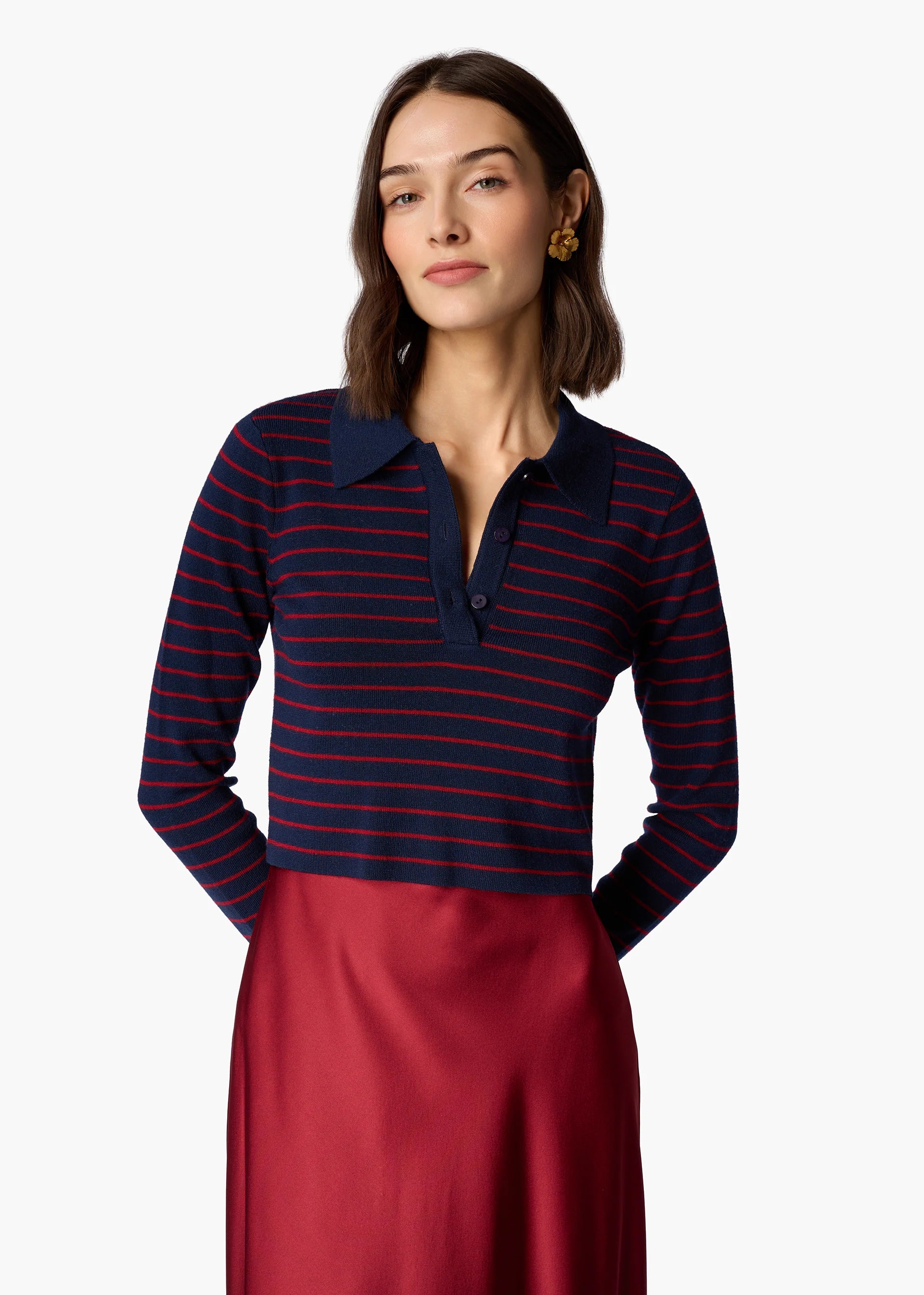 Woman wearing a navy and red striped long-sleeve shirt with a white background