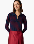 Woman wearing a navy and red striped long-sleeve shirt with a white background