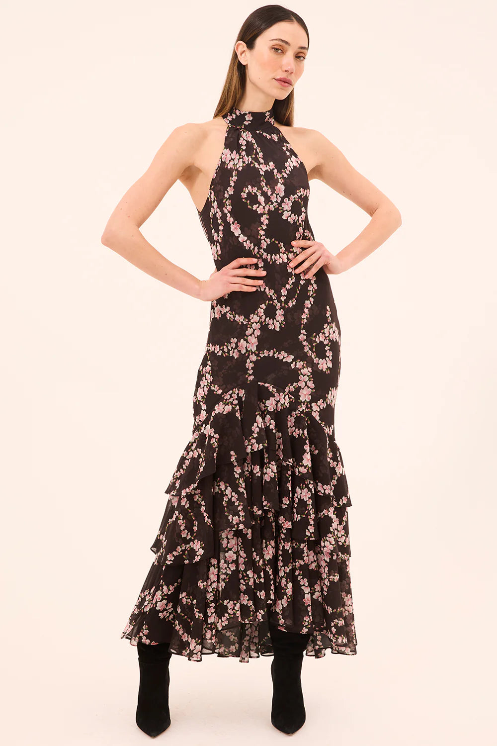 Woman wearing a black floral dress on a white background