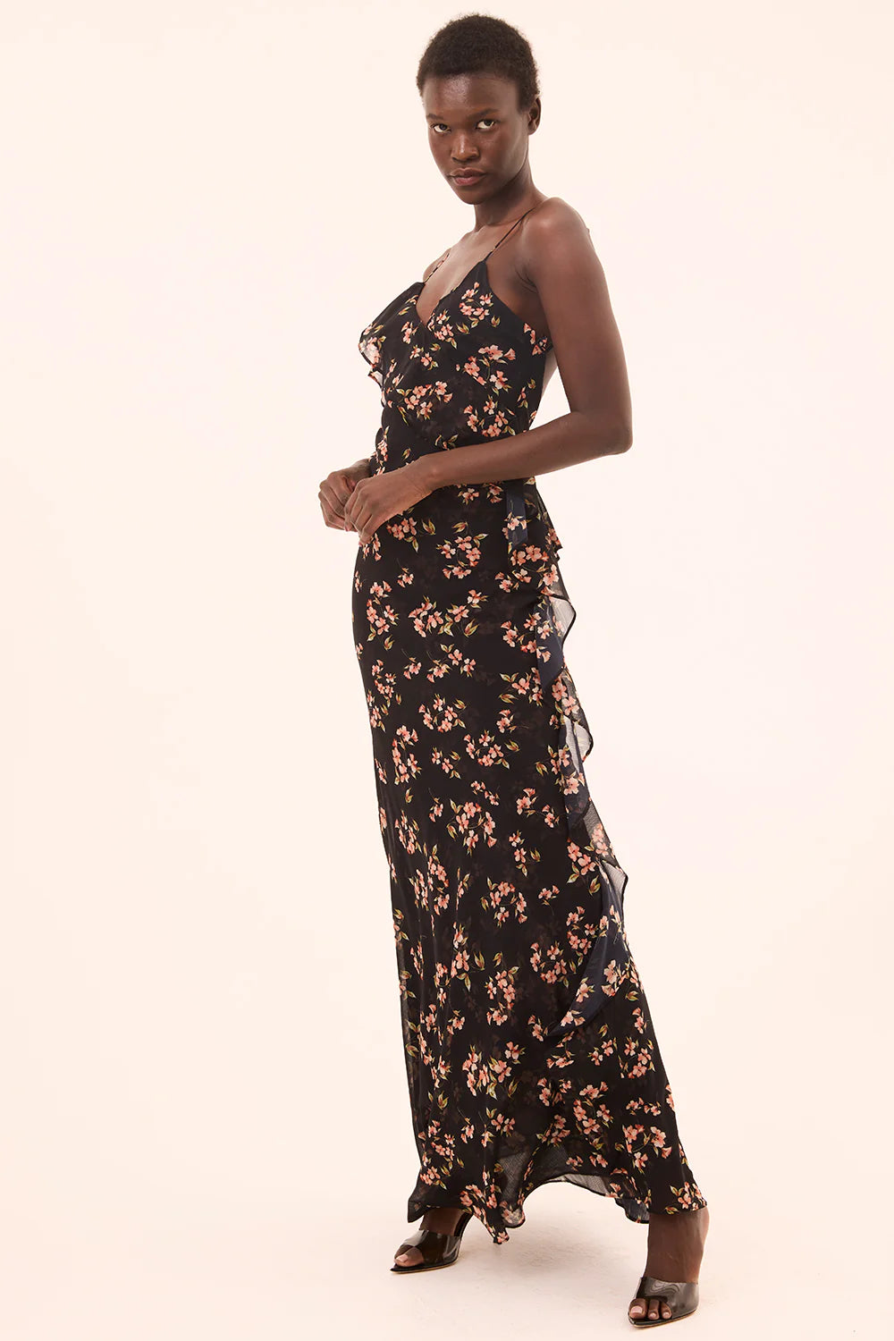 Woman wearing a black floral dress on a white background