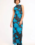 A sleeveless high-neck maxi dress with a black base and a vibrant blue floral pattern, modeled against a plain white studio background.
