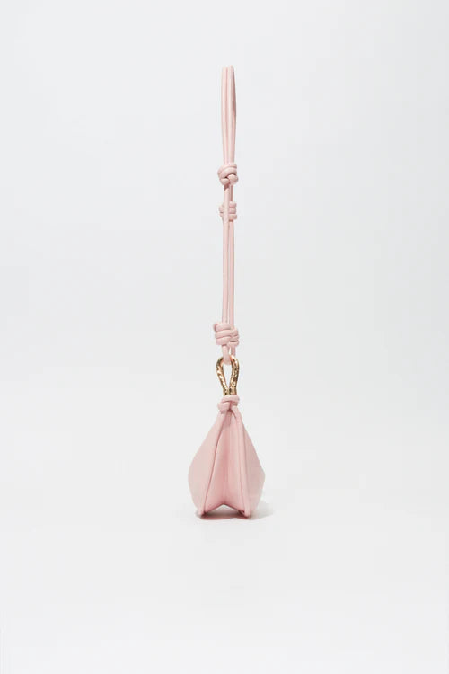 Pink dog toy with a handle on a white background