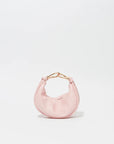 Pink handbag with gold handle on a light gray background
