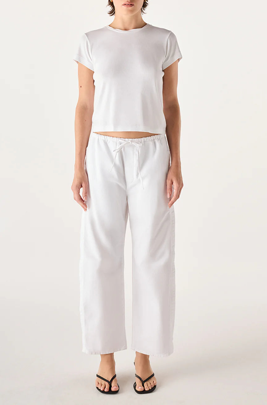 model wearing the simone white pant and a short sleeve with tee with a white background, front 