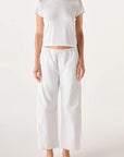 model wearing the simone white pant and a short sleeve with tee with a white background, front 