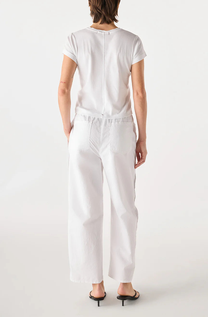model wearing the simone white pant and a short sleeve with tee with a white background, back