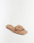 A single fluffy teddy-texture slide sandal in a warm beige or light tan color, photographed on a clean white studio background.