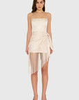 model wearing a cream colored romper with fringe scarf detail