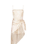 Photo of a wearing a cream colored romper with fringe scarf detail on a white background