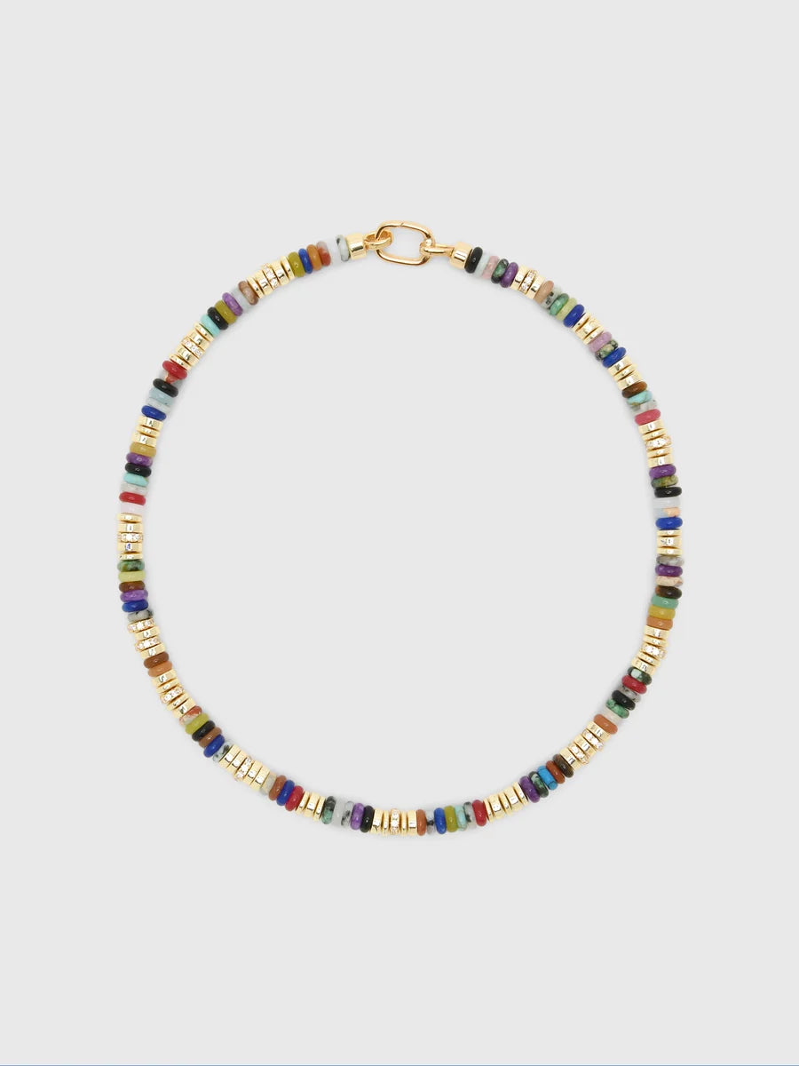 A gold-tone beaded necklace with small cylindrical beads in multiple colors including blue, green, red, and purple, arranged in alternating gold and multicolor bead patterns, shown on a light gray background.