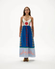 Woman wearing a colorful dress with patterns on a white background