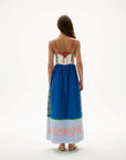 Woman wearing a colorful dress with patterns on a white background, back