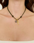 Necklace with a gold fish pendant on a person's neck