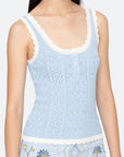 Light blue lace tank top with floral embroidery on a plain background