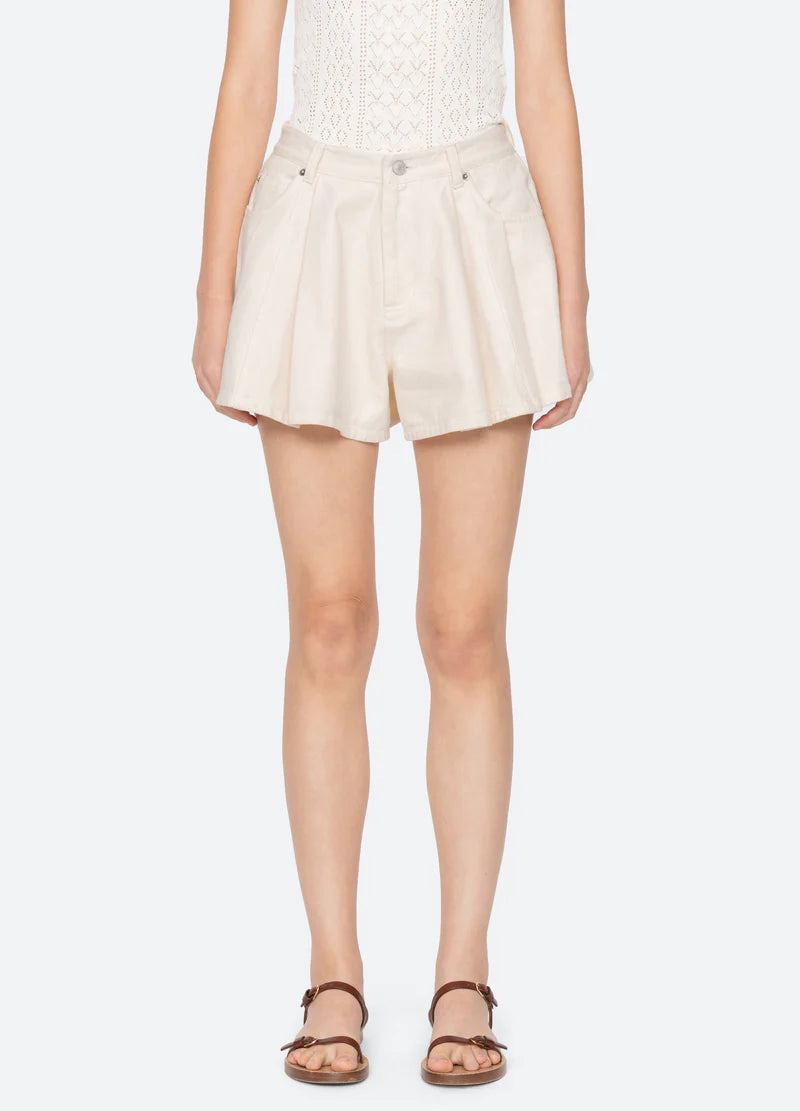 Beige shorts worn by a person on a white background