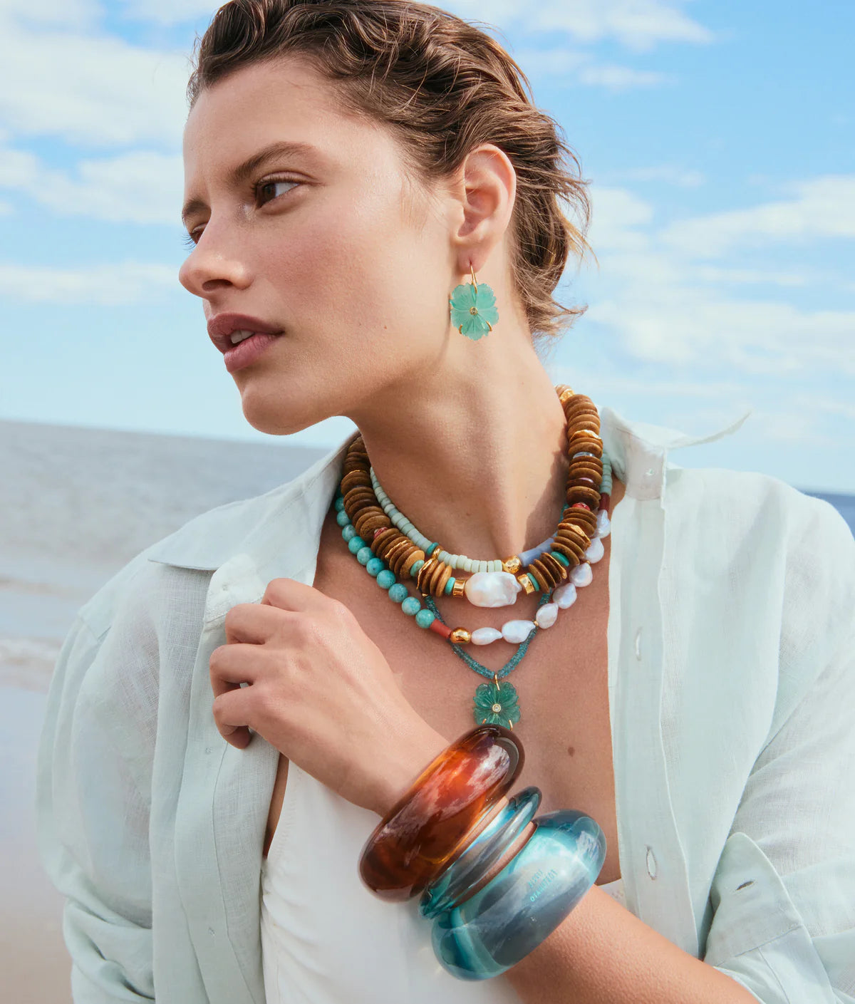 New Bloom Earring in Capri on model with New Bloom Necklace in Capri and other stacked necklaces and bracelets