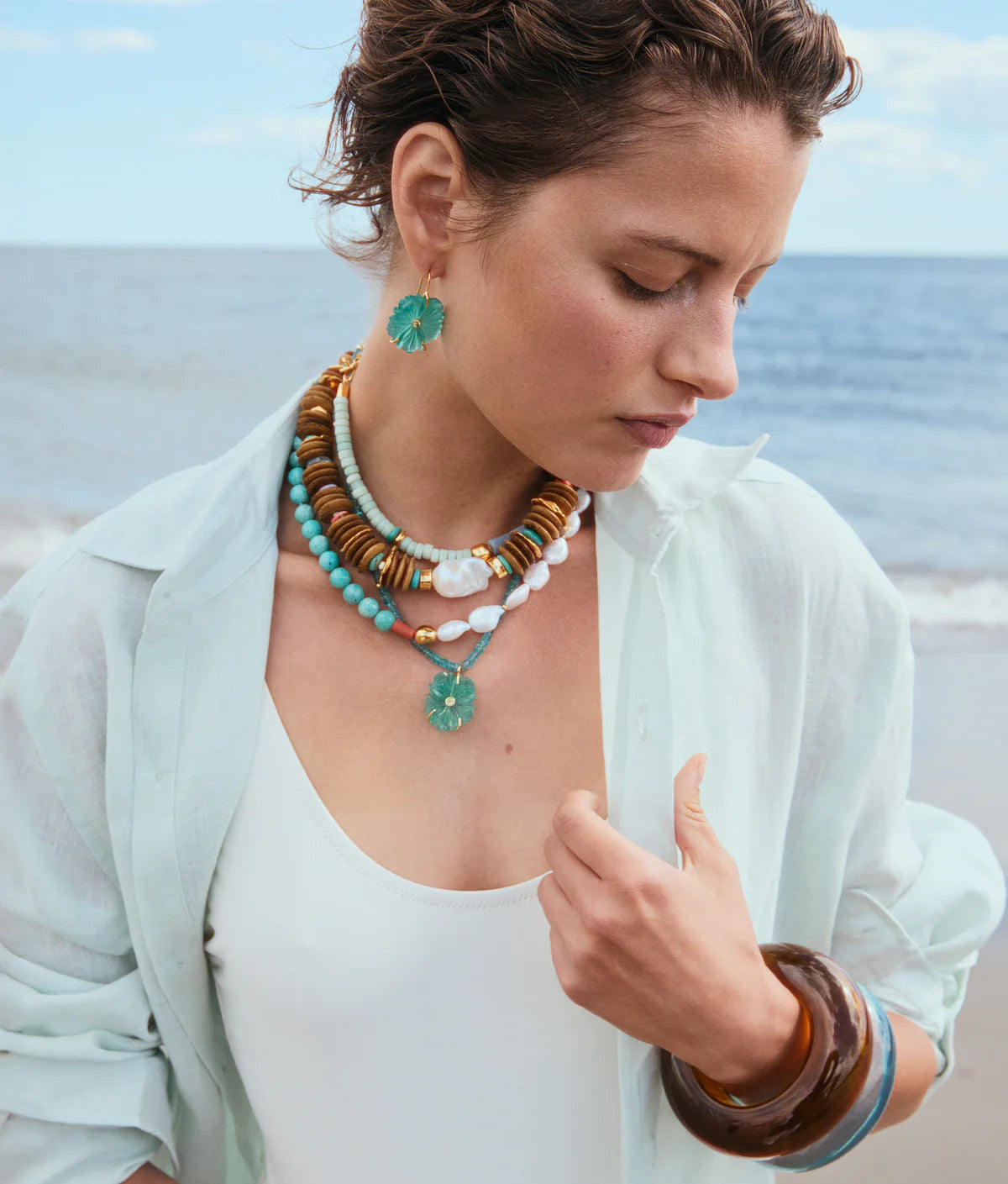 Woman wearing colorful jewelry on a beach