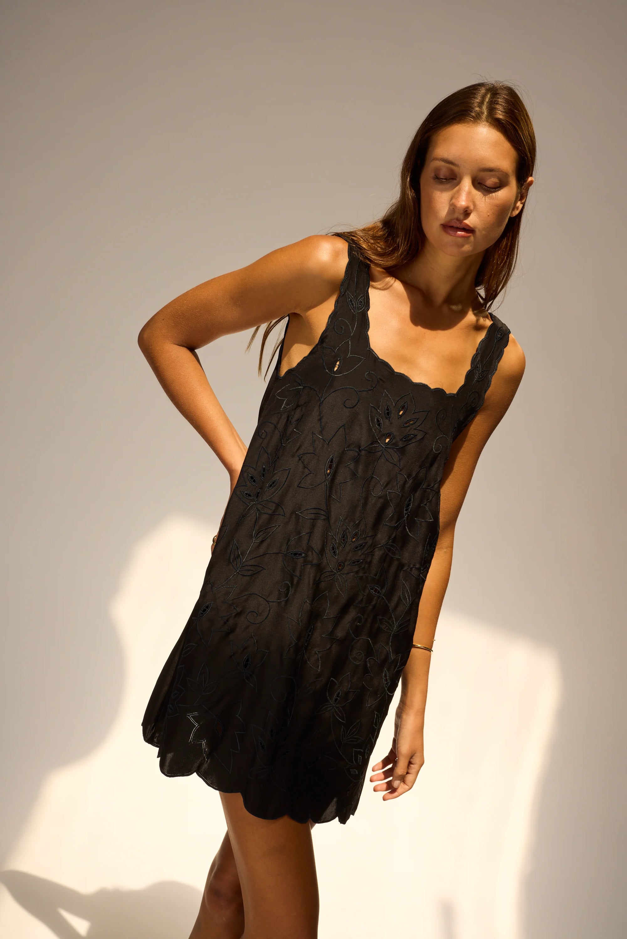 Nadia Dress front view with tilted angle of model in front of white wall